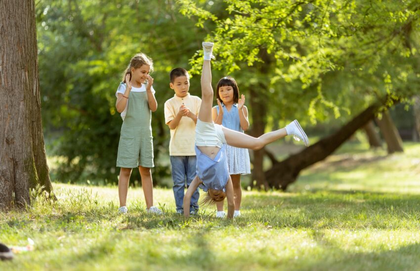 Group of asian and caucasian kids having fun in the park