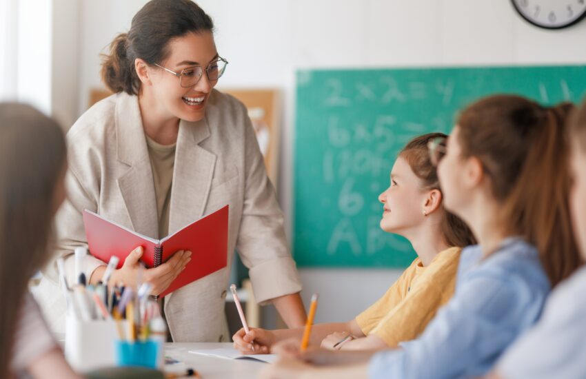 Happy kids and teacher at school