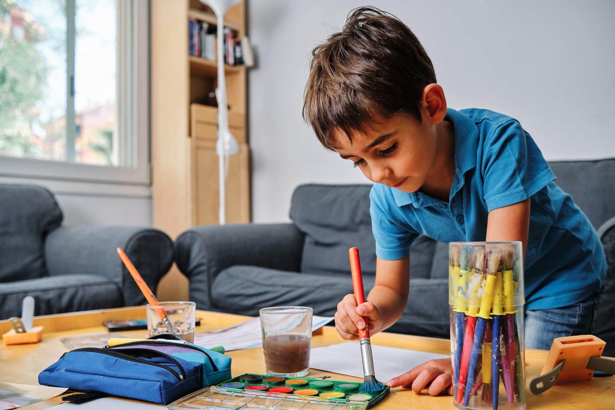 young kid playing with colors and drawing